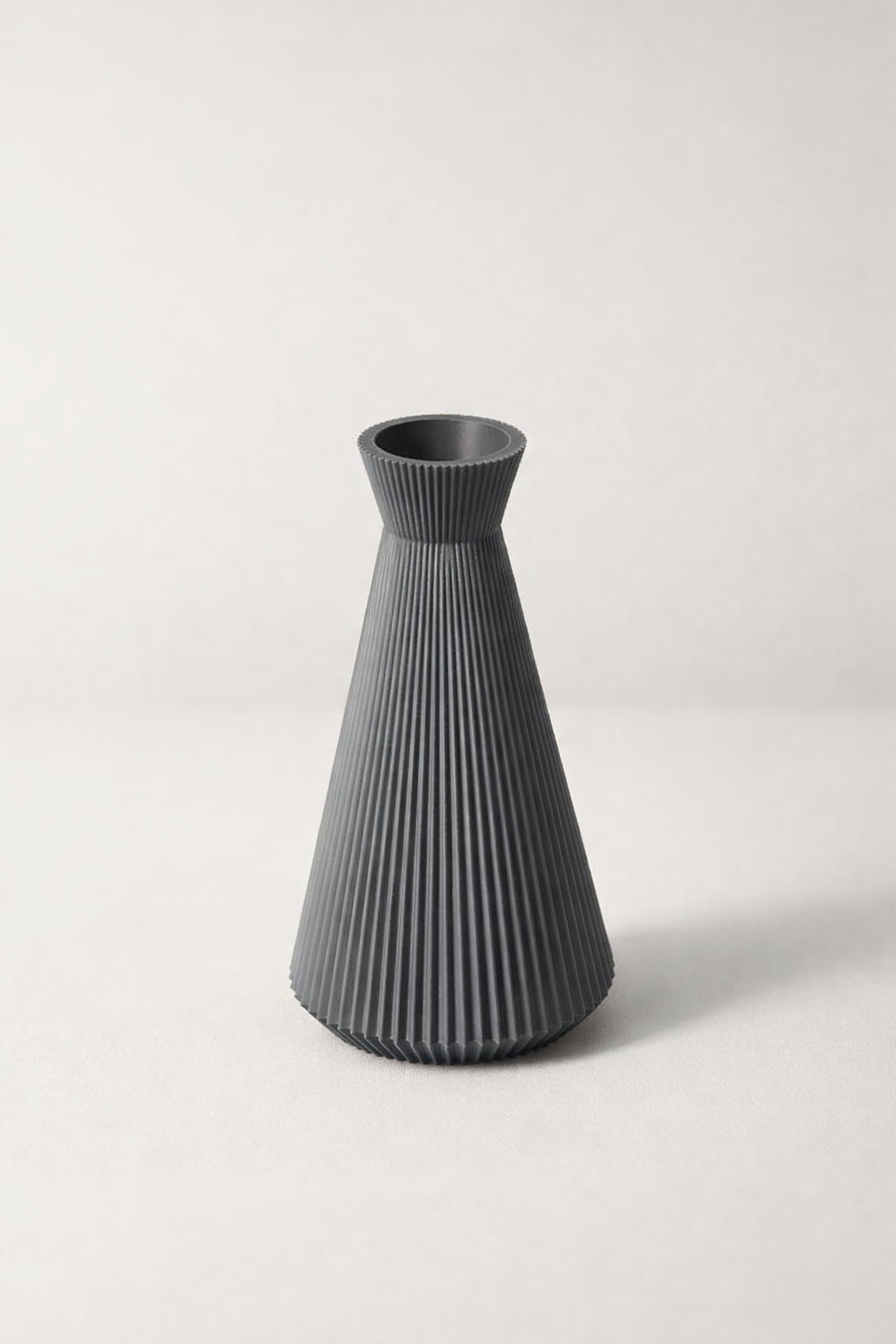 Gray ribbed vase on a white background